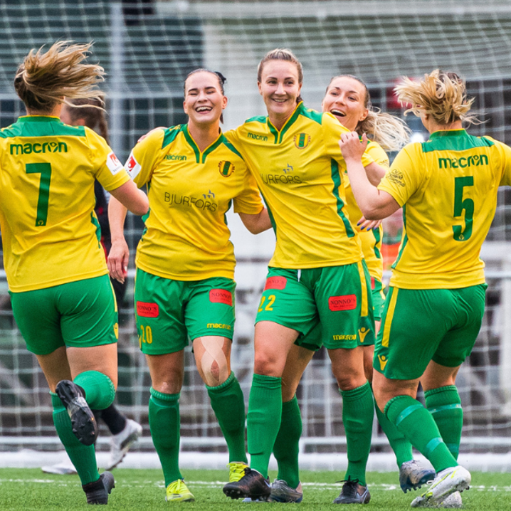 Fotbollstjejer iklädda Bollstanäs matchkläder springer till varandra för att krama om varandra