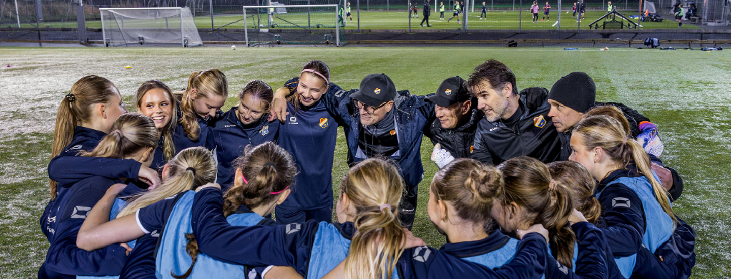 Ett flickfotbollslag har samlats i klunga för att snacka ihop sig