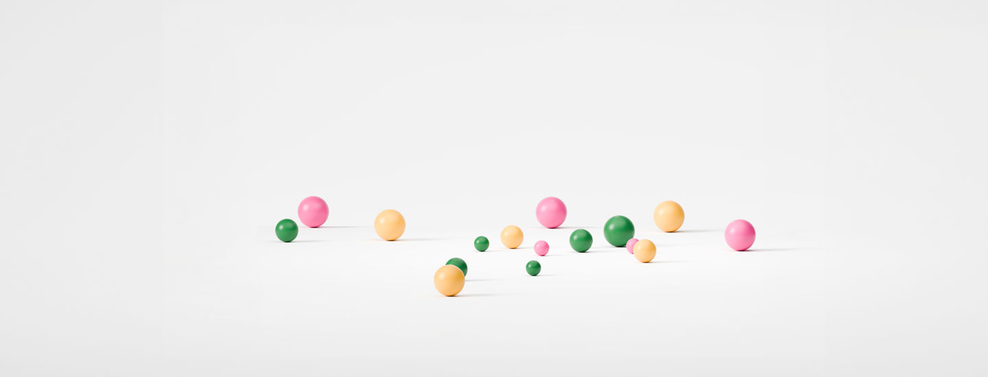 3D-bollar i joyna färger mot vit bakgrund