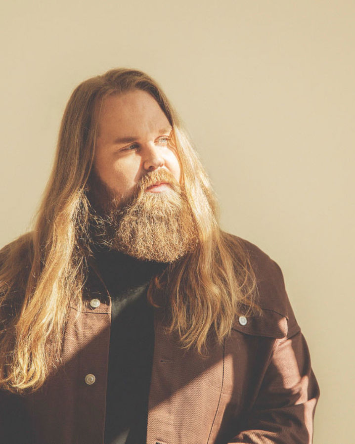 Chris Kläfford vänd mot ett fönster där solen skiner in