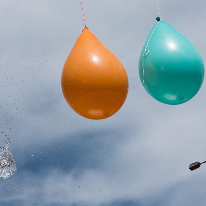 Vattenfyllda ballonger och en kastad dartpil